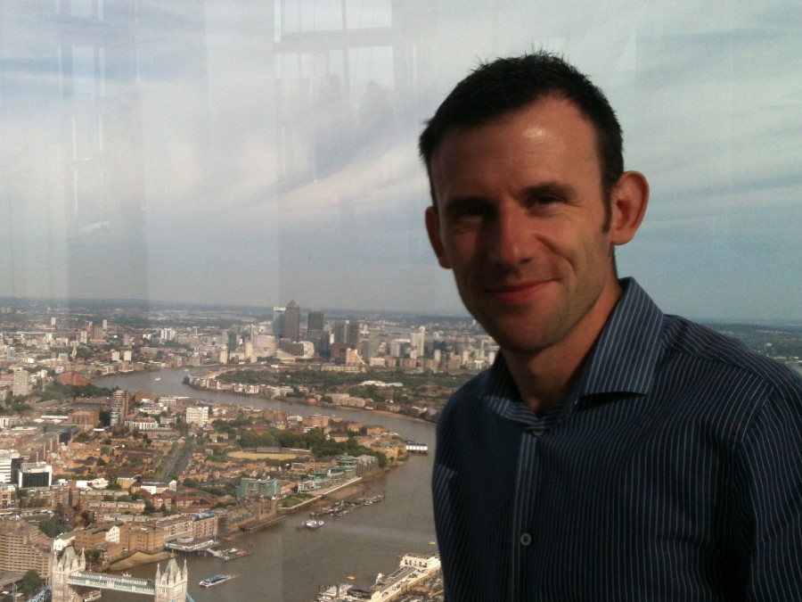 A person standing in front of a window

Description automatically generated